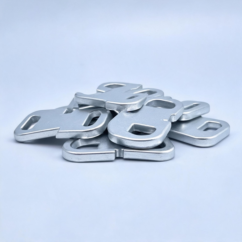 Tumbled and deburred raw aluminum parts with smooth matte surface